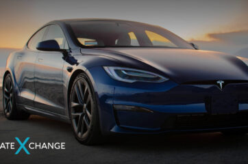 Front of Tesla electric car at sunset on the beach