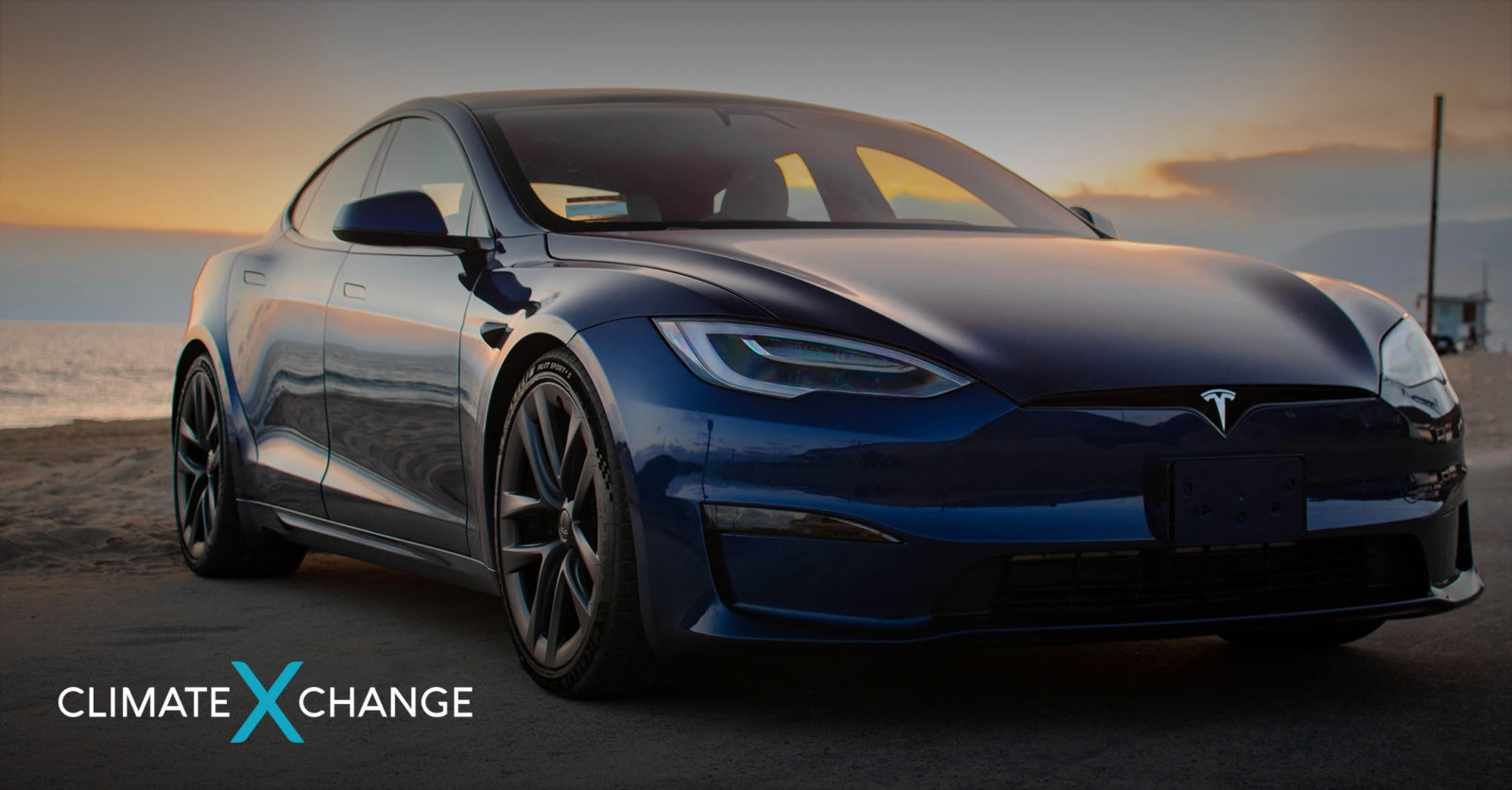 Front of Tesla electric car at sunset on the beach